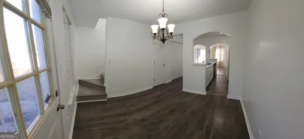 a view of a room with wooden floor and staircase