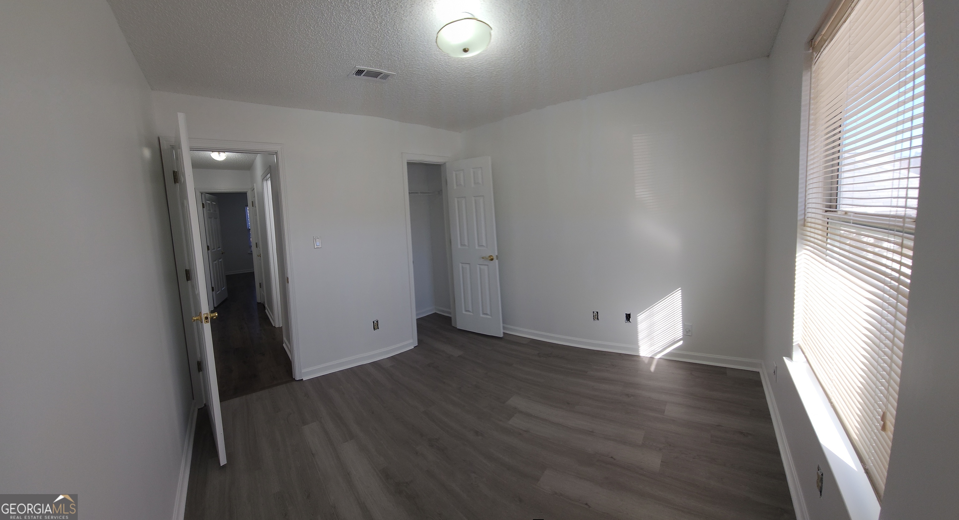200 Glynn Addy Drive Stockbridge, GA 30281 - Photo 14 of 28 an empty room with wooden floor and windows