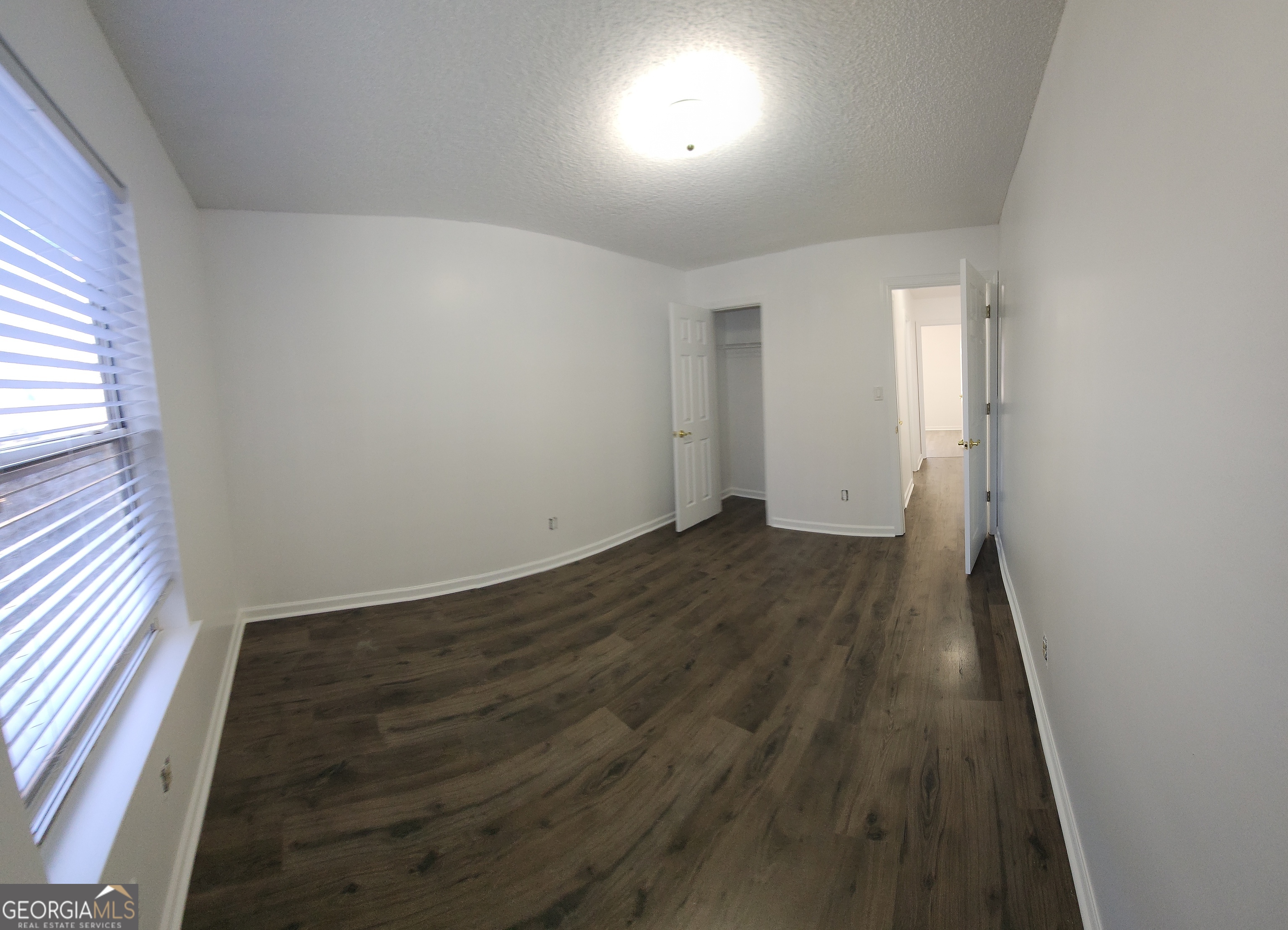 200 Glynn Addy Drive Stockbridge, GA 30281 - Photo 17 of 28 an empty room with wooden floor and windows