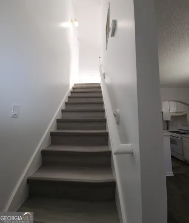 a view of entryway and hall with wooden floor