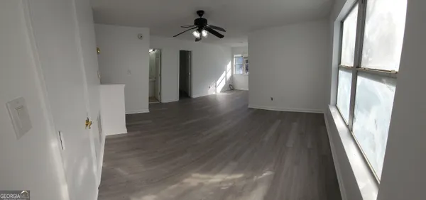 a view of a hallway view with wooden floor and staircase
