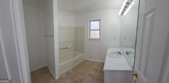 a bathroom with a tub and a shower