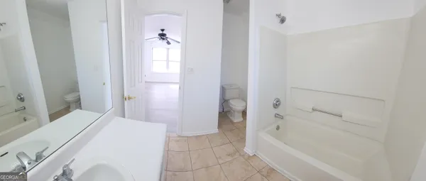 a bathroom with a tub and shower