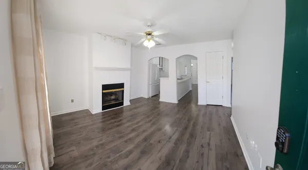 wooden floor in an empty room with a fireplace
