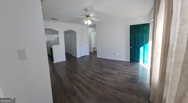 a view of a room with wooden floor and staircase