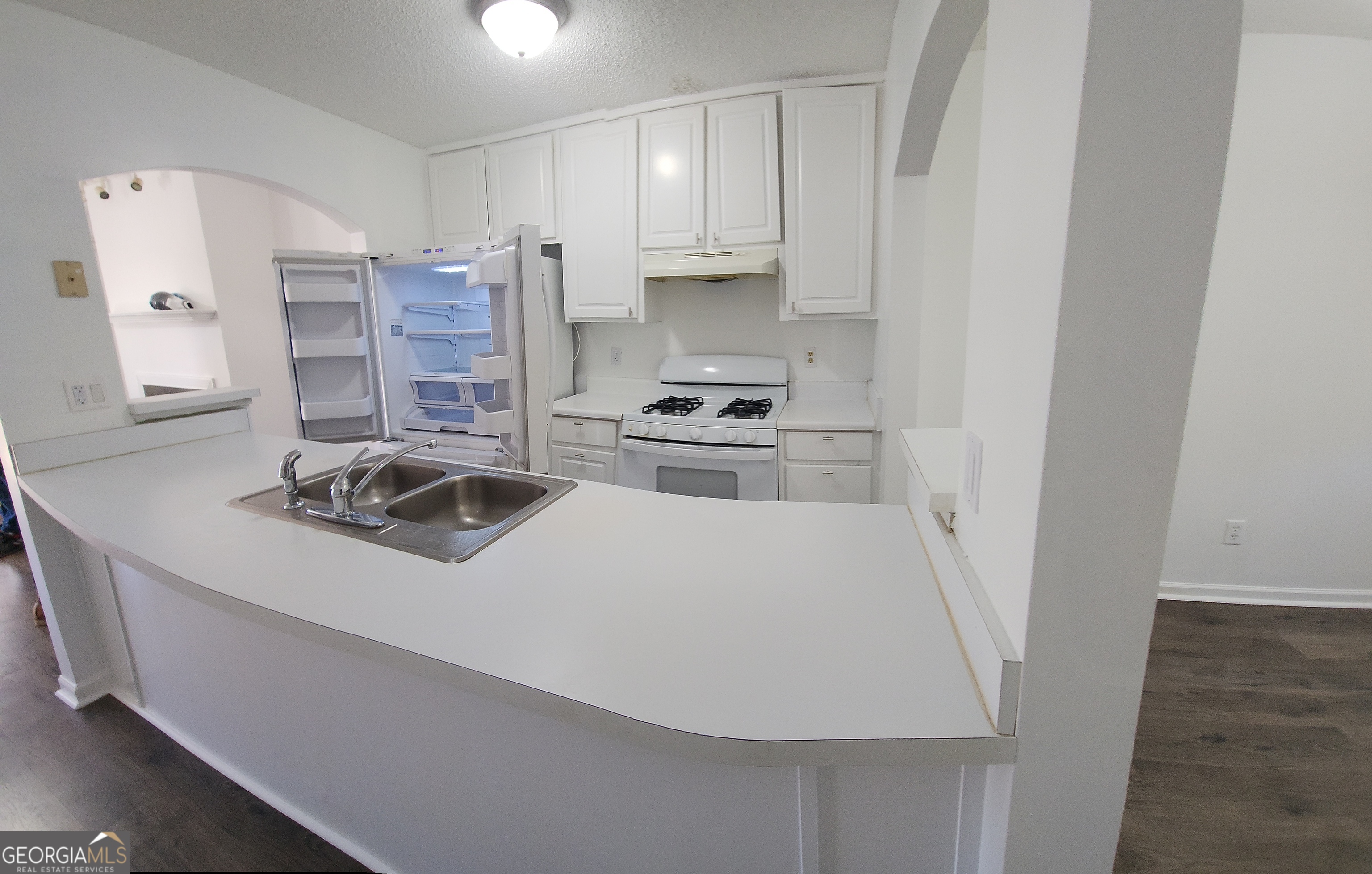 200 Glynn Addy Drive Stockbridge, GA 30281 - Photo 10 of 28 a kitchen with a white stove top oven and sink