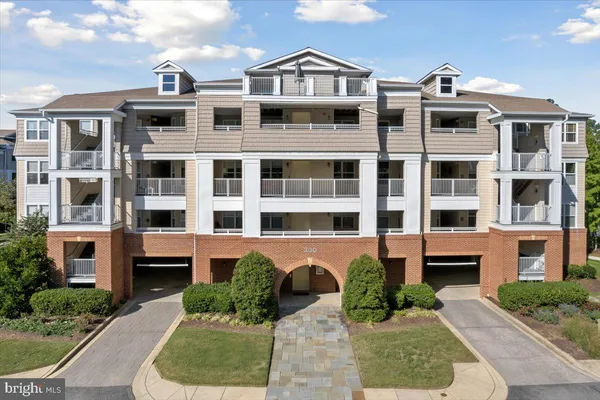 a front view of a residential apartment building with a yard