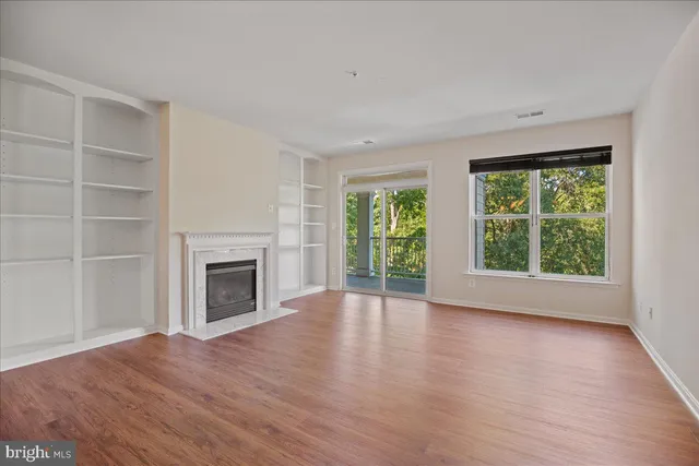 wooden floor fireplace and natural light in room