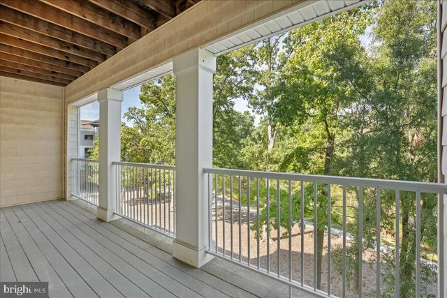 a view of a balcony with wooden floor