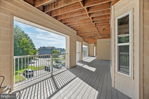 a view of a balcony with wooden floor