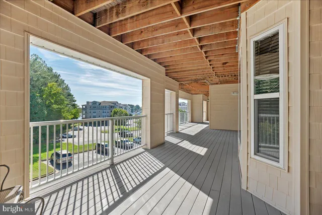 a view of a balcony with wooden floor