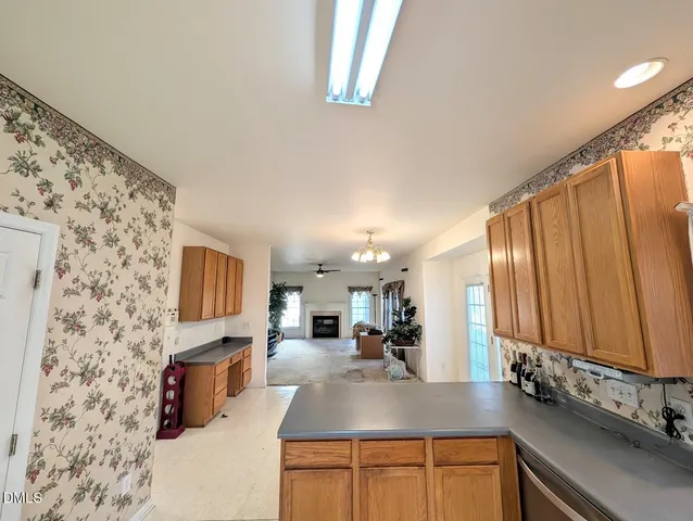 a view of a living room and kitchen with a large window