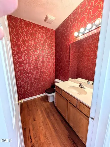 an empty room with windows and fireplace