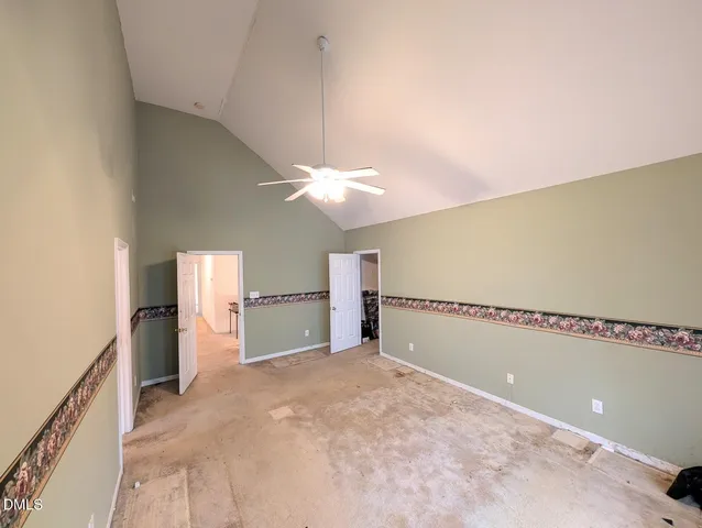 a view of a livingroom with a ceiling fan and window