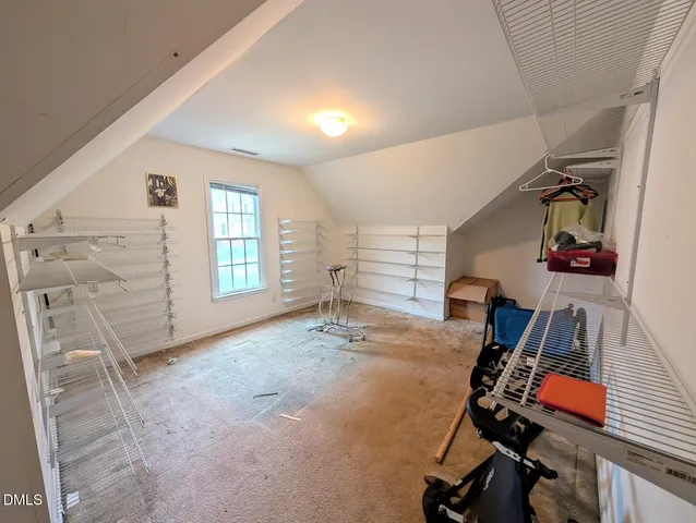 a view of a room with cabinet and a ceiling fan