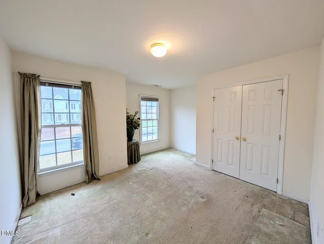 an empty room with potted plants