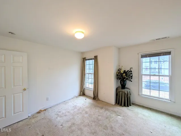 an empty room with windows and closet