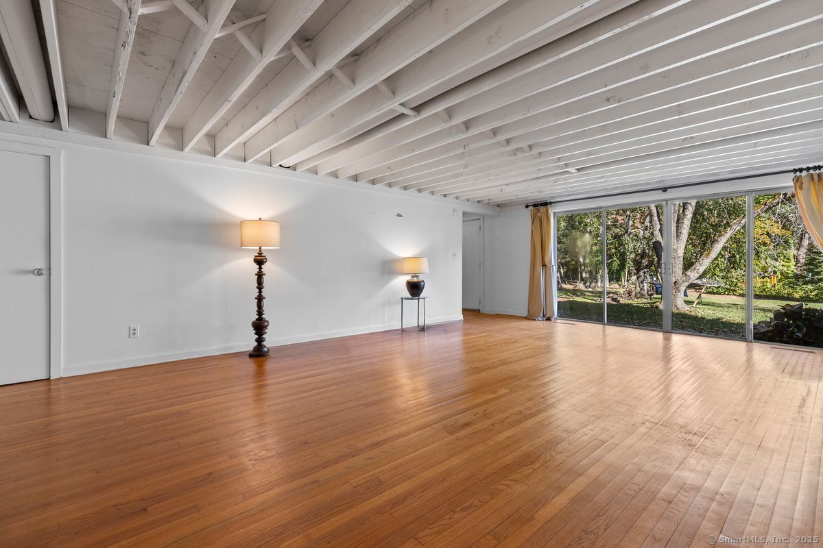 1166 Old Racebrook Road Woodbridge, CT 06525 - Photo 11 of 29 a view of empty room with wooden floor and fan