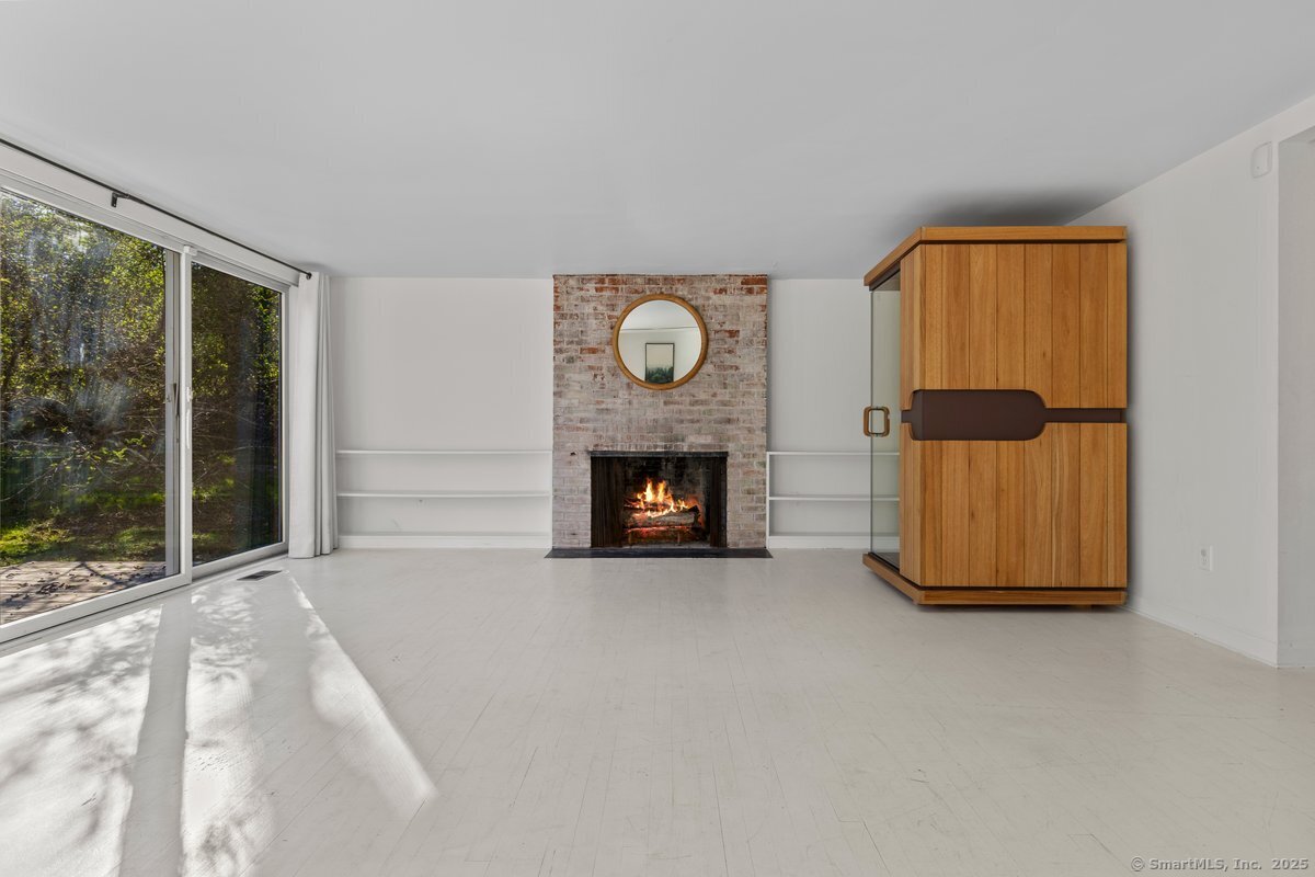 1166 Old Racebrook Road Woodbridge, CT 06525 - Photo 12 of 29 a view of an empty room with a fireplace and a window