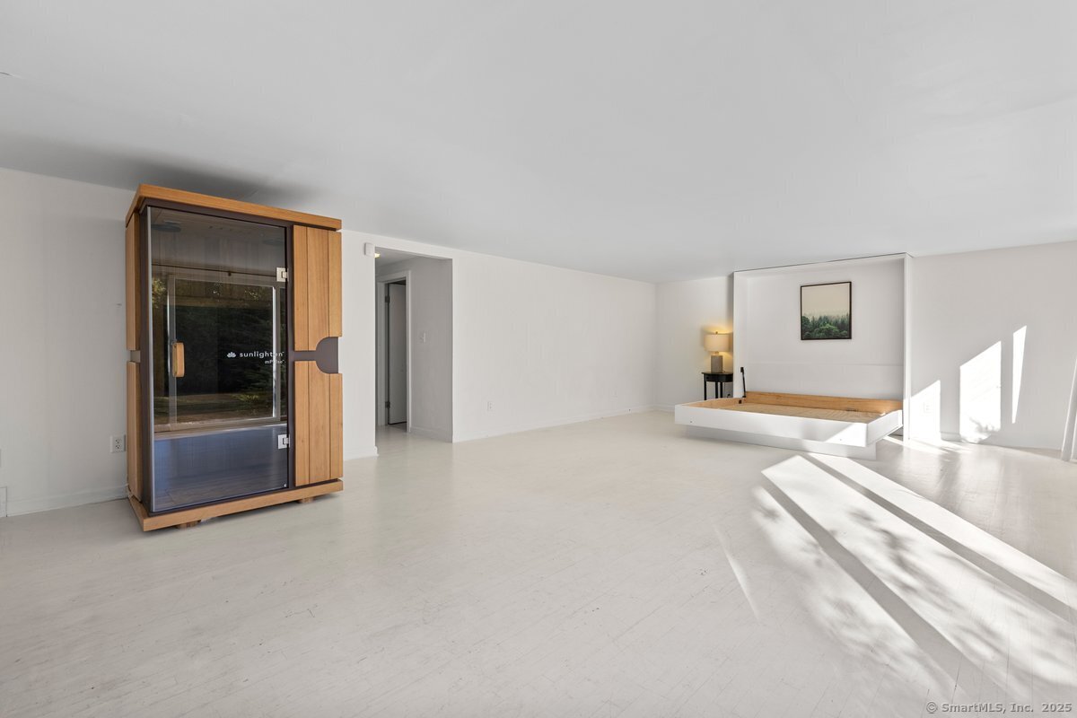 1166 Old Racebrook Road Woodbridge, CT 06525 - Photo 13 of 29 a spacious bedroom with a bed and a mirror