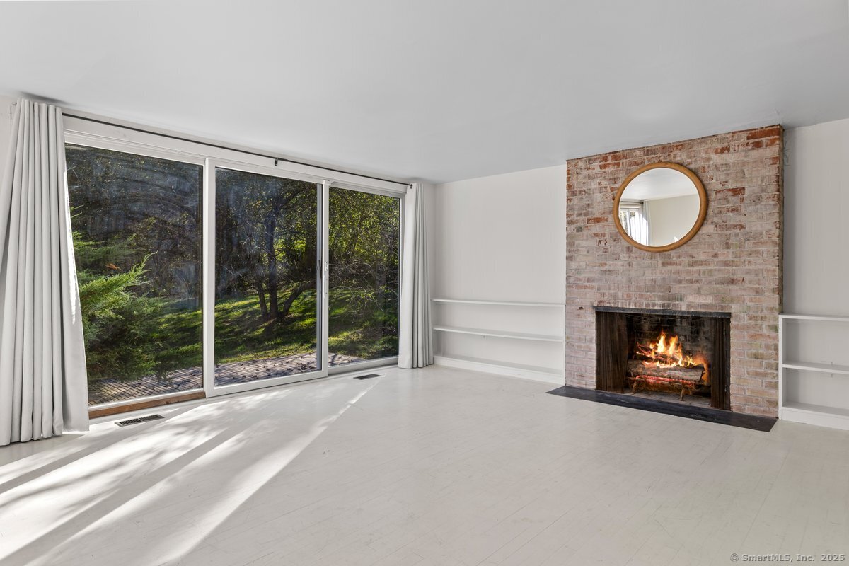 1166 Old Racebrook Road Woodbridge, CT 06525 - Photo 14 of 29 a living room with furniture and a fireplace