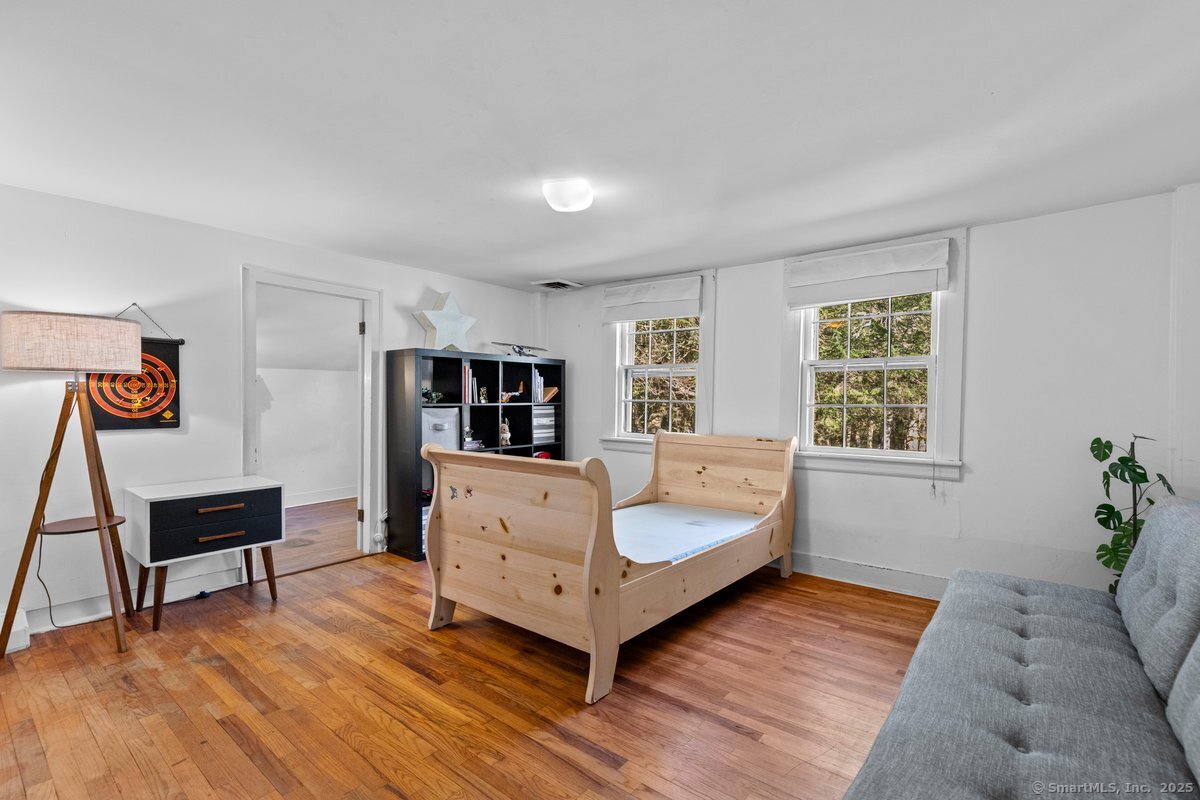 1166 Old Racebrook Road Woodbridge, CT 06525 - Photo 19 of 29 a living room with furniture and a window