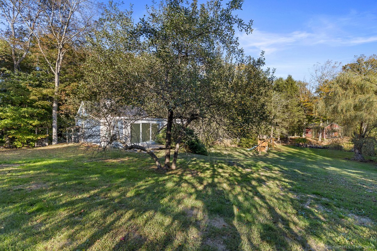1166 Old Racebrook Road Woodbridge, CT 06525 - Photo 21 of 29 a backyard of a house with table and chairs