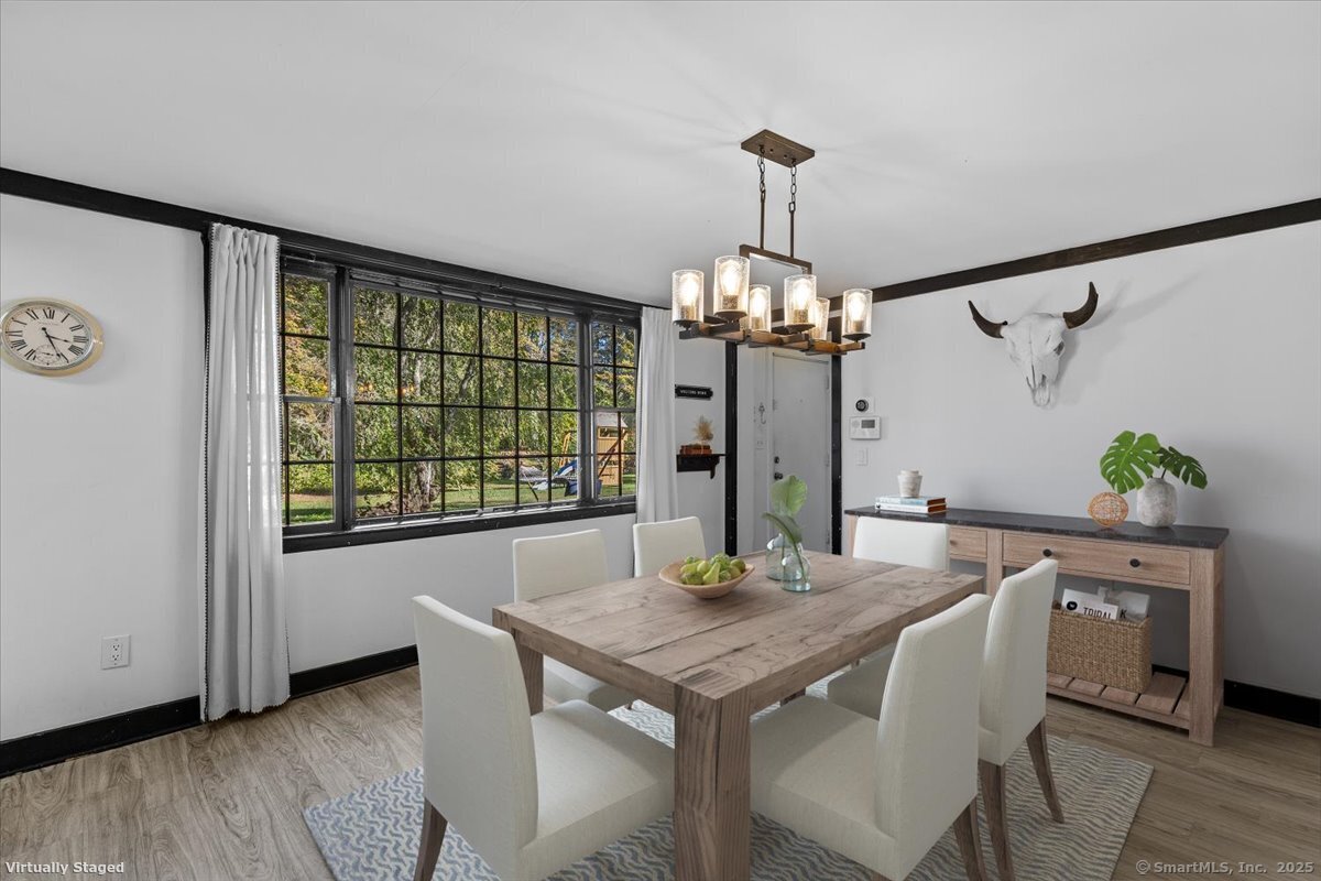 1166 Old Racebrook Road Woodbridge, CT 06525 - Photo 27 of 29 a view of a dining room with furniture window and wooden floor