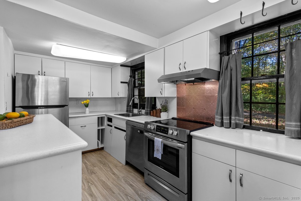 1166 Old Racebrook Road Woodbridge, CT 06525 - Photo 5 of 29 a kitchen with a stove a sink and a refrigerator