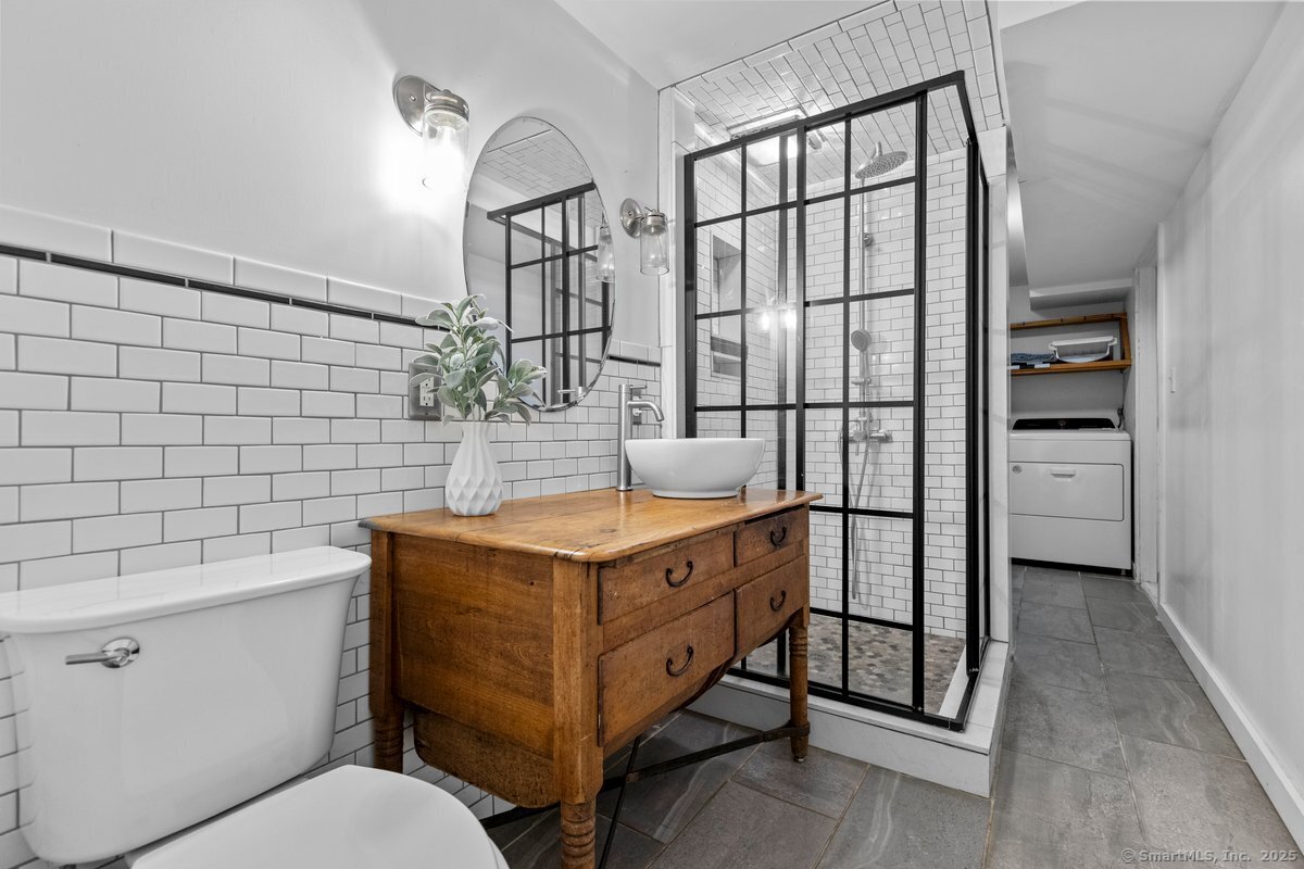 1166 Old Racebrook Road Woodbridge, CT 06525 - Photo 8 of 29 a bathroom with a sink toilet and shower