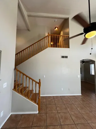 a view of staircase with railing and white walls