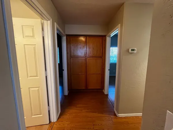a view of a hallway with wooden floor