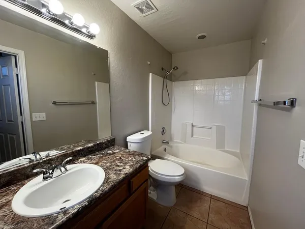 a bathroom with a sink toilet tub and shower