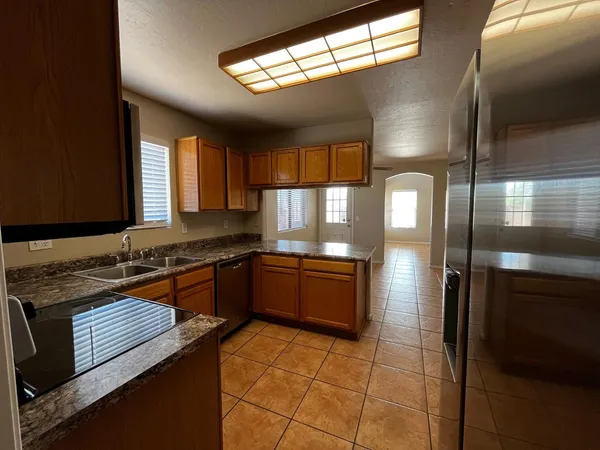 a kitchen with a sink a stove cabinets and a counter top space