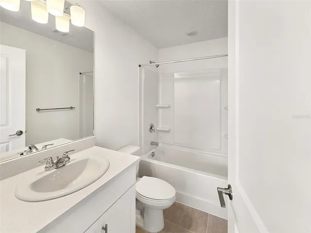 a bathroom with a sink toilet tub and shower