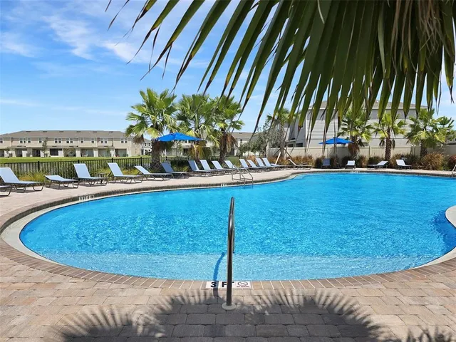 a view of swimming pool with outdoor seating and plants