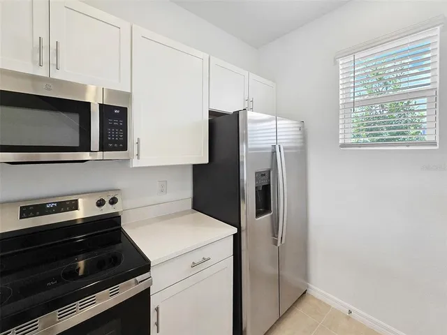 a kitchen with stainless steel appliances a refrigerator stove and microwave