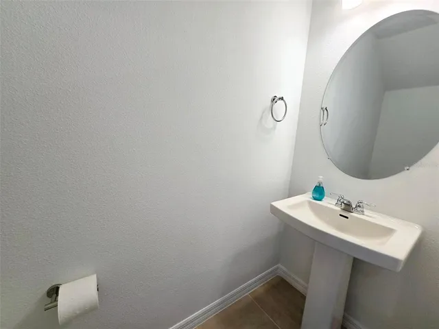 a bathroom with a sink mirror and vanity