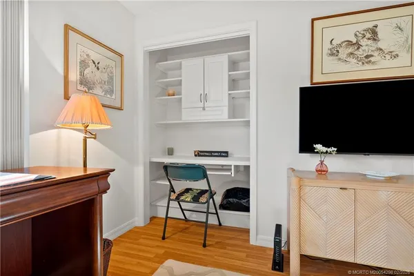 a view of a workspace with furniture and wooden floor