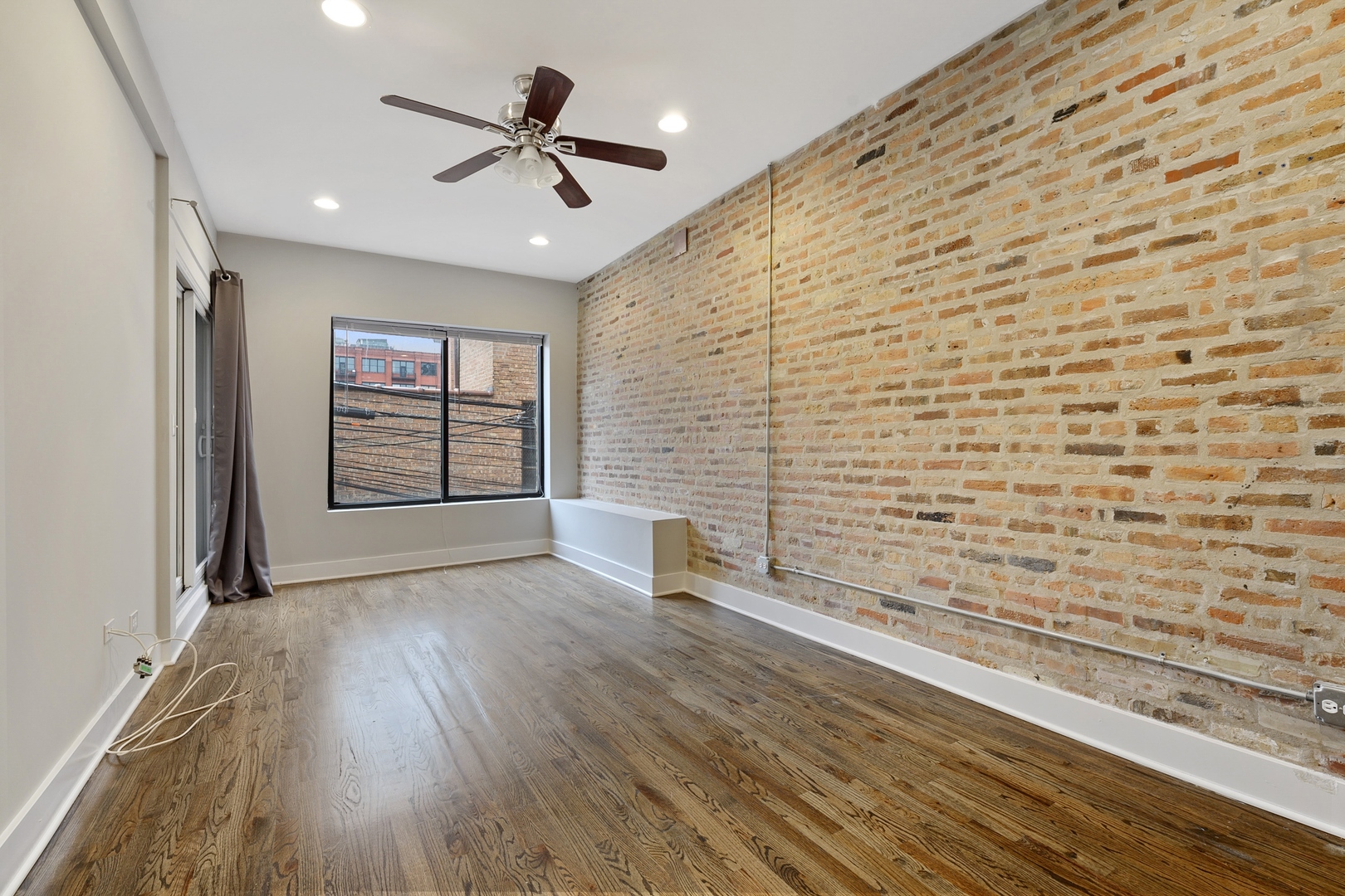 1015 West Lake Street, Unit 2E Chicago, IL 60607 - Photo 13 of 19 a view of an empty room and a window with wooden floor