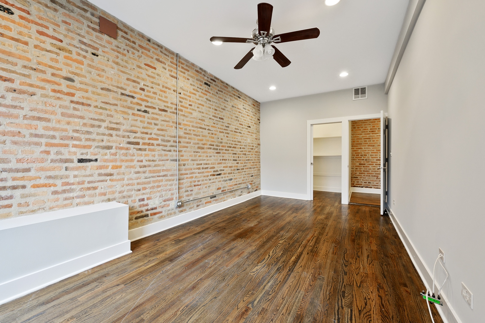1015 West Lake Street, Unit 2E Chicago, IL 60607 - Photo 14 of 19 wooden floor in an empty room with a window