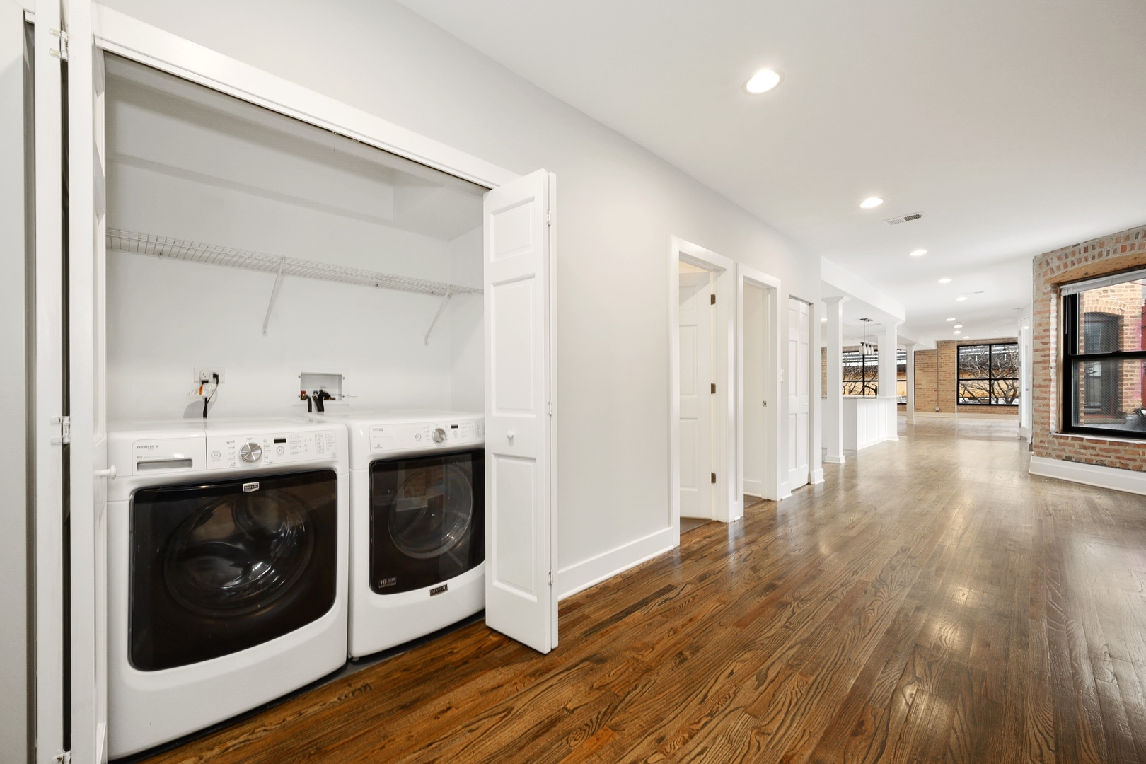1015 West Lake Street, Unit 2E Chicago, IL 60607 - Photo 18 of 19 a view of a hallway with wooden floor and a fireplace
