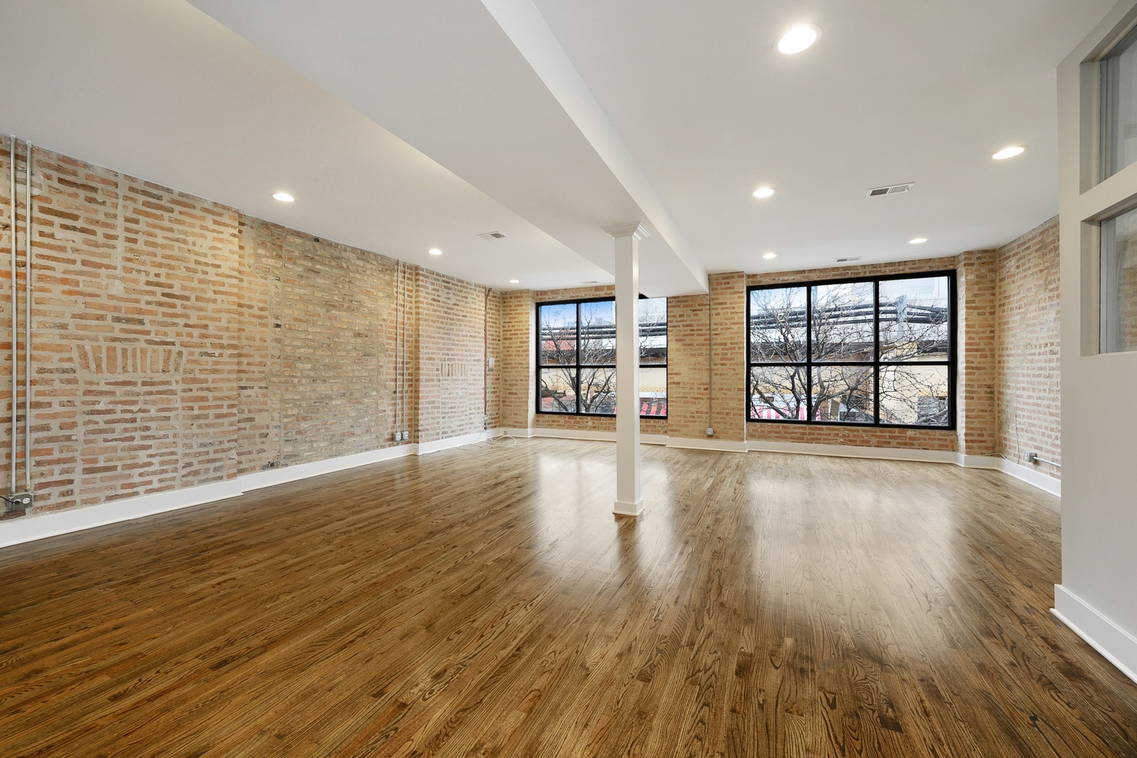 1015 West Lake Street, Unit 2E Chicago, IL 60607 - Photo 5 of 19 a view of an empty room with a window and wooden floor