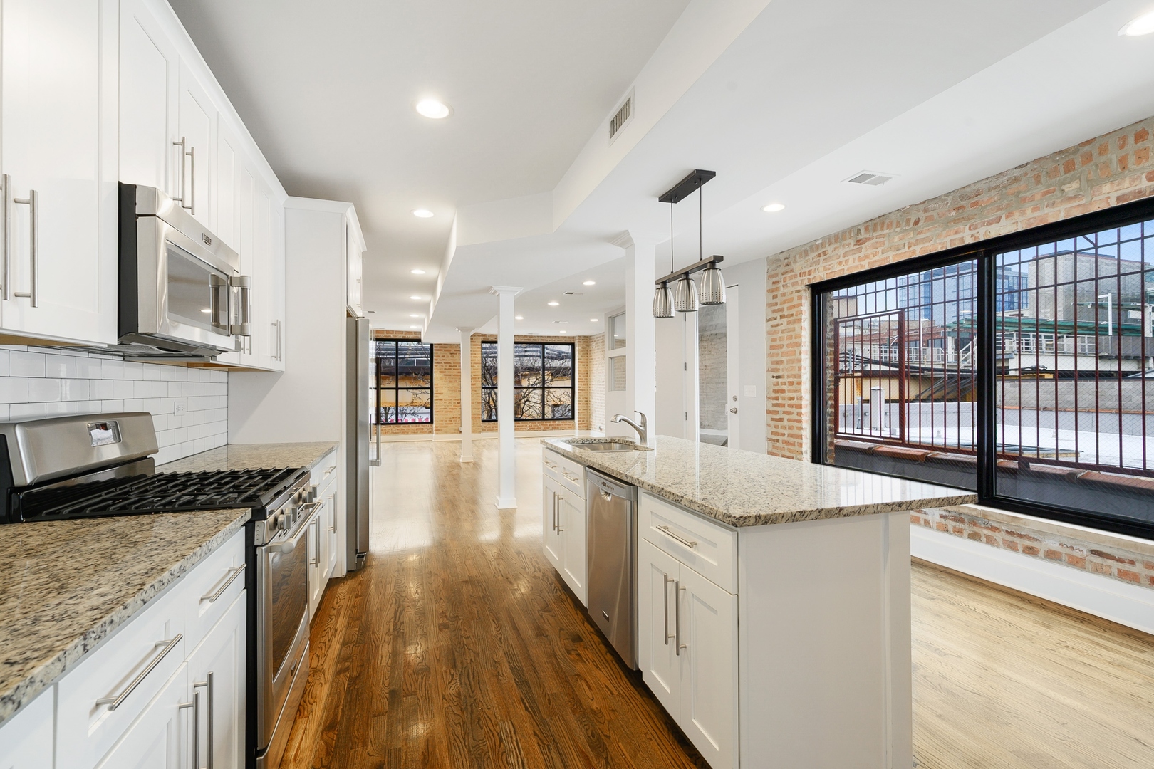 1015 West Lake Street, Unit 2E Chicago, IL 60607 - Photo 7 of 19 a open kitchen with stainless steel appliances granite countertop a stove and a sink