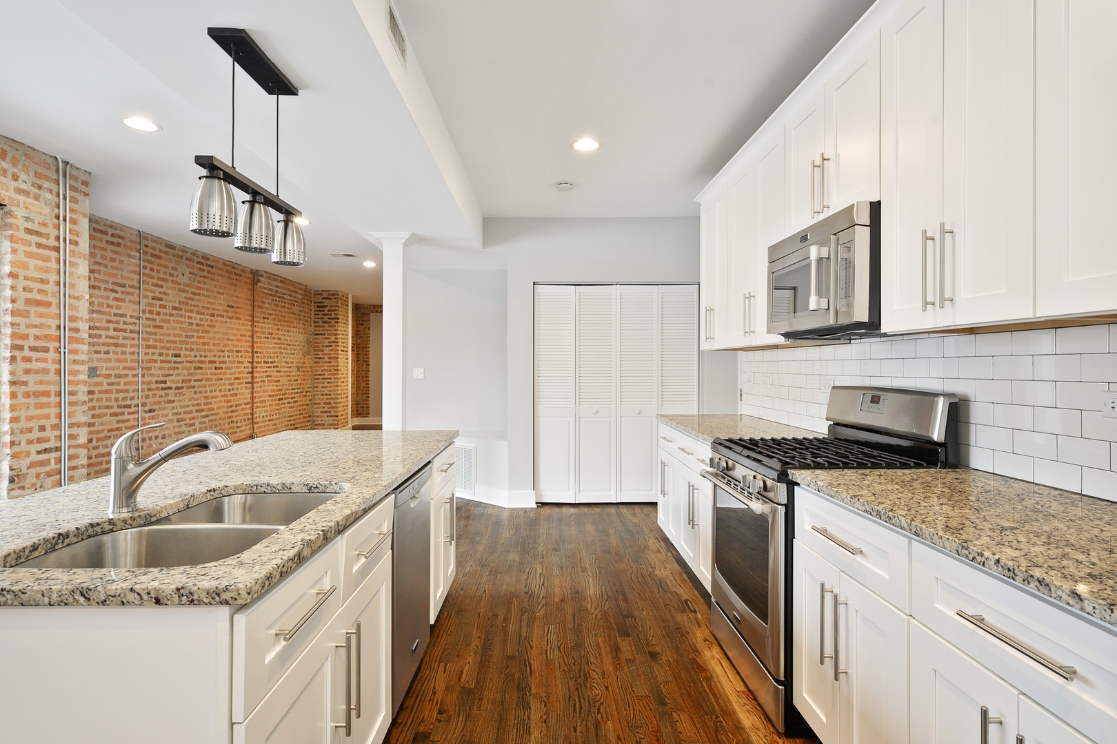 1015 West Lake Street, Unit 2E Chicago, IL 60607 - Photo 8 of 19 a kitchen that has a sink a stove and cabinets