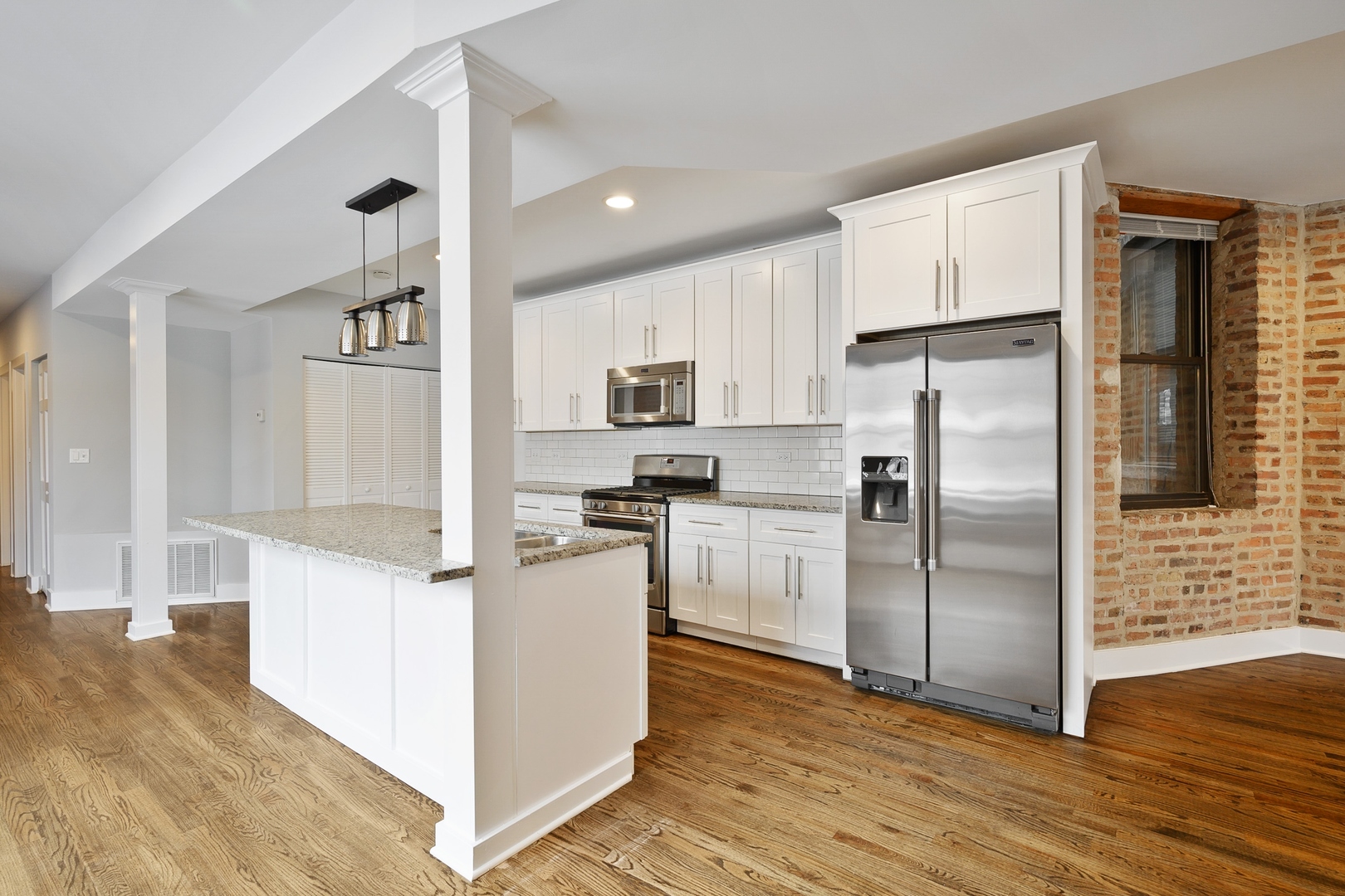 1015 West Lake Street, Unit 2E Chicago, IL 60607 - Photo 9 of 19 a kitchen with white cabinets and stainless steel appliances