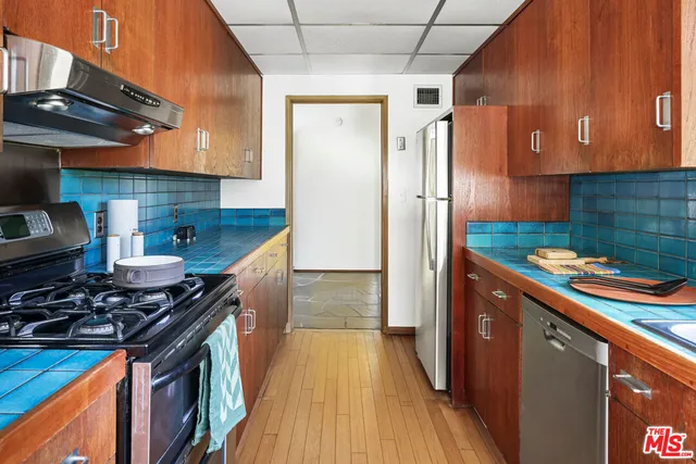 a kitchen with stainless steel appliances granite countertop a stove and a refrigerator