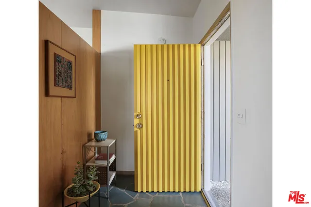 a view of a room with a door and furniture