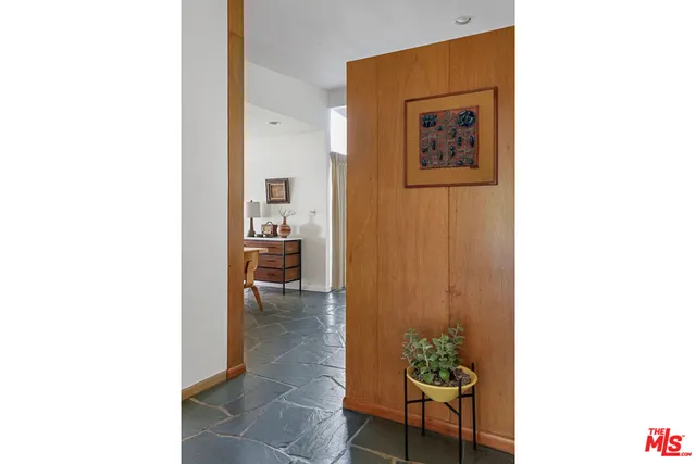 a living room with furniture and a dining table