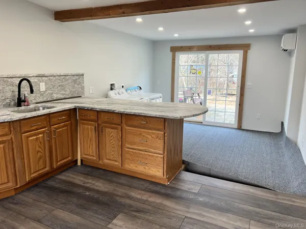 a kitchen with a sink cabinets and wooden floor